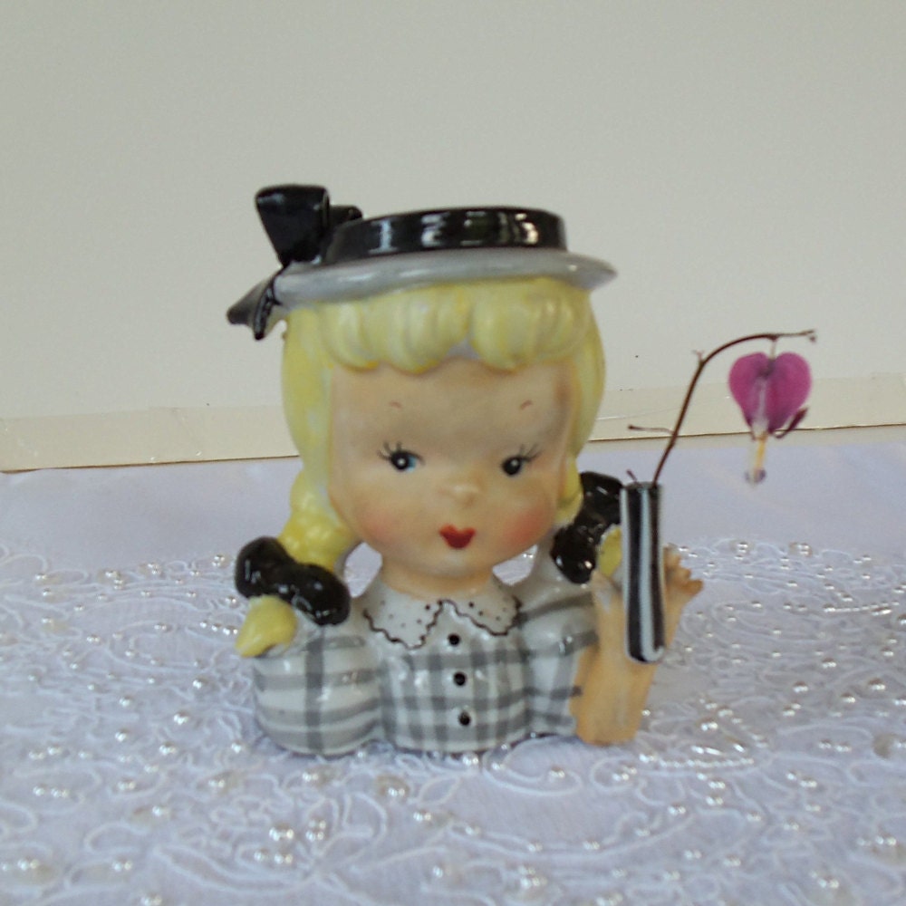 Vintage porcelain Doll Head Vase,girl with pigtails and checkered blouse, yellow and black, holding mini vase, flawless condition