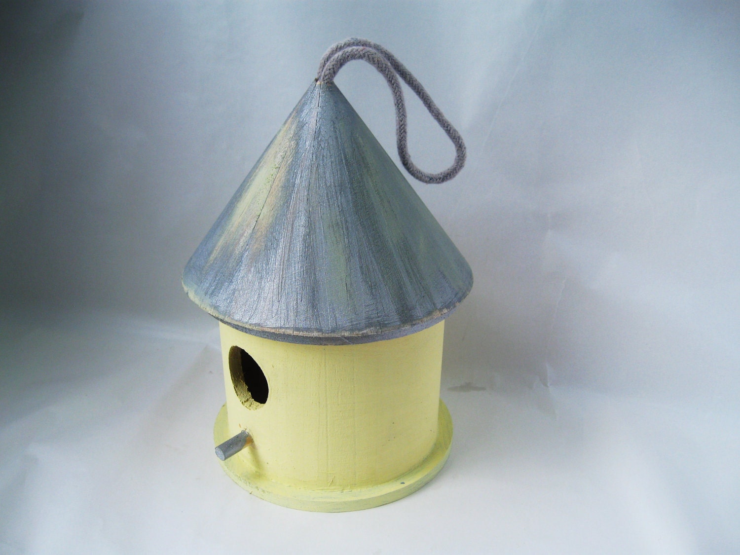 Rustic bird house, yellow and blue.  Feed the birds in style.