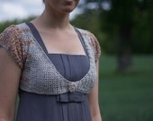 Silver radiant bolero size 36 to 38 EU, volant sleeves and deep decollete.