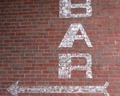 White Bar Sign on Red Brick Photograph