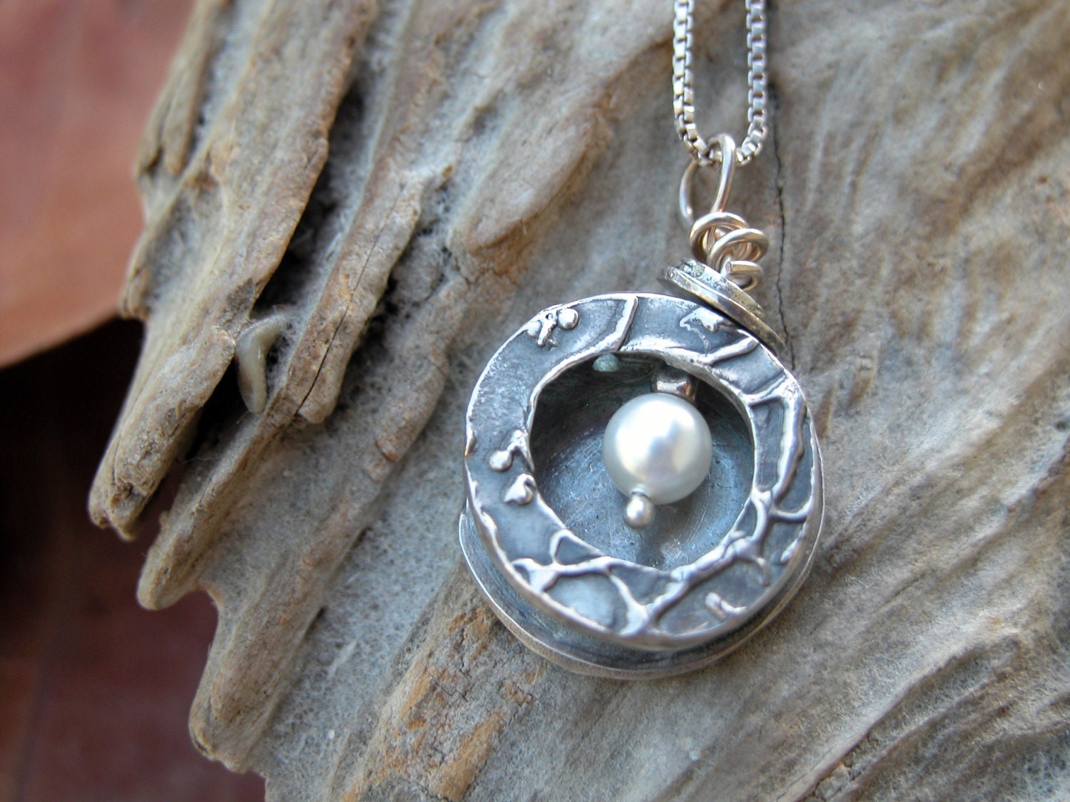 Silver necklace with pearl in a box