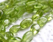 Peridot smooth oval beads, irregular 5-8mm, 14 inch strand