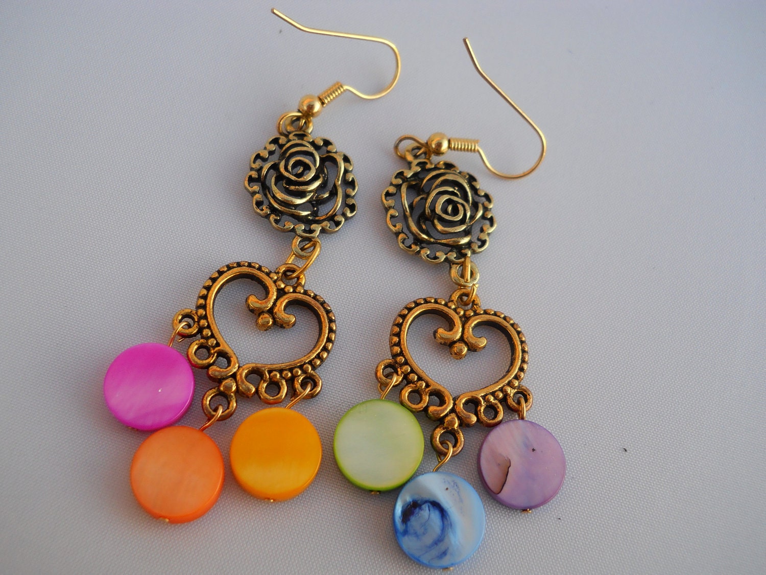earrings: rose links, heart-shaped chandeliers, rainbow mother-of-pearl coins
