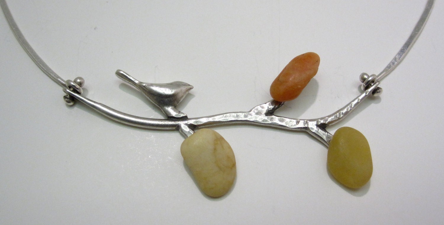 Silver Bird on Branch with River Stones