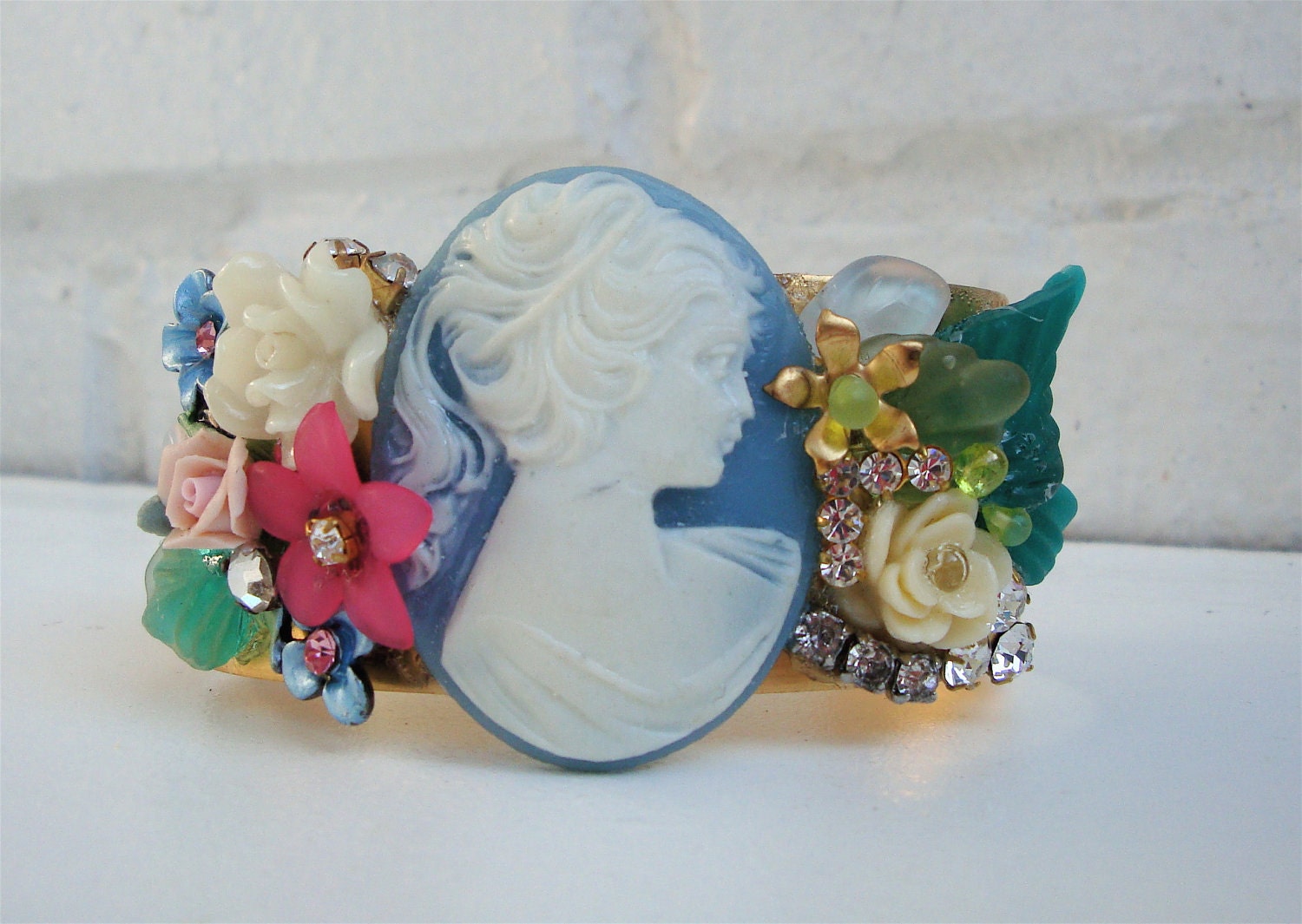 Vintage brass cuff bracelet with beautiful powder blue cameo, enamel and carved roses, flowers, crystals, rhinestones and  leaves .