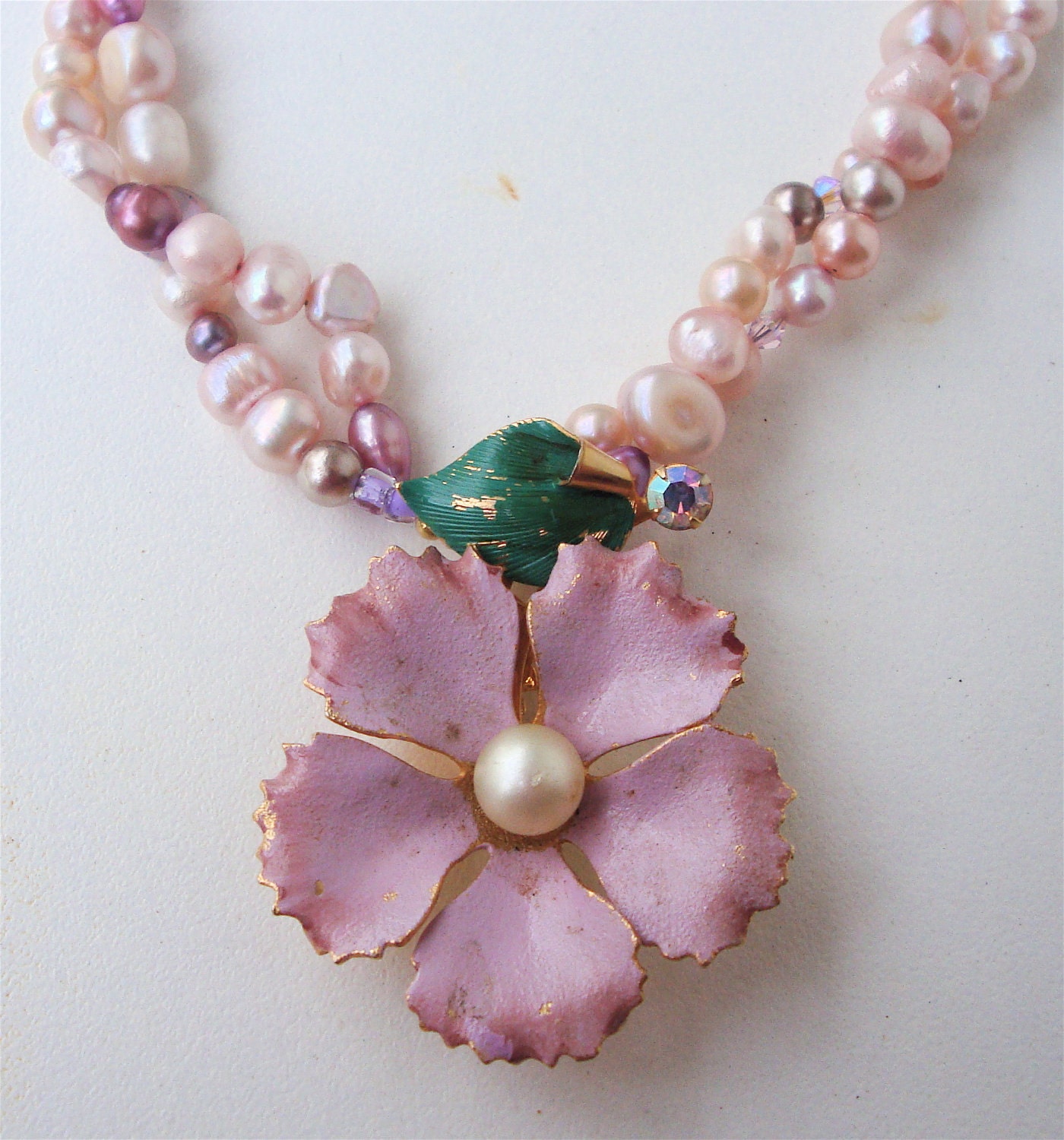 Vintage enamel flower  brooch converted to a pendant for this dyed fresh water pearl necklace with tiny swarovski crystals.