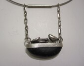 Bird and nest on cut river stone