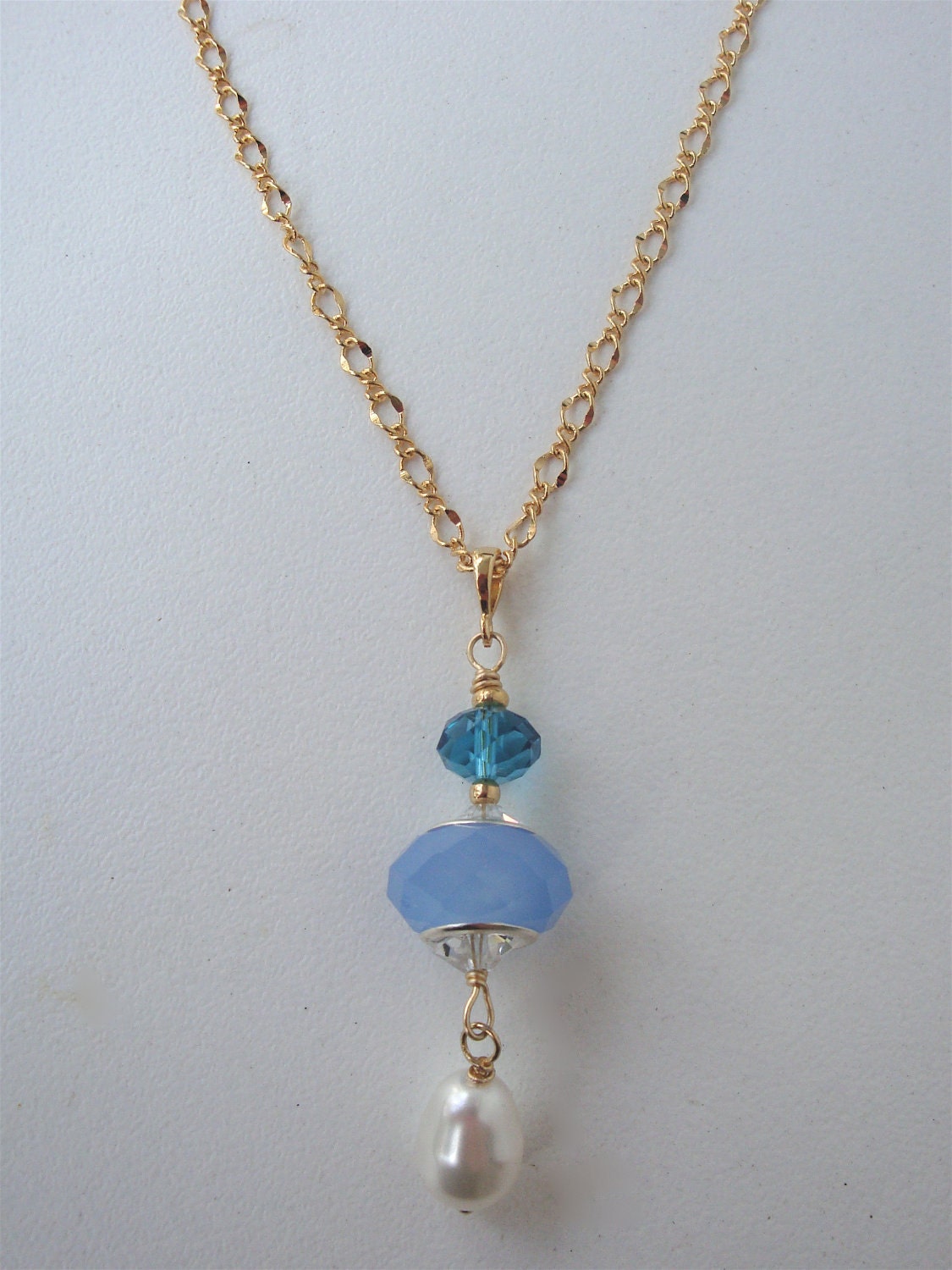Dangling pendant necklace, lariat style, with swarovski pearl and crystal and "pandora" style bead in between.