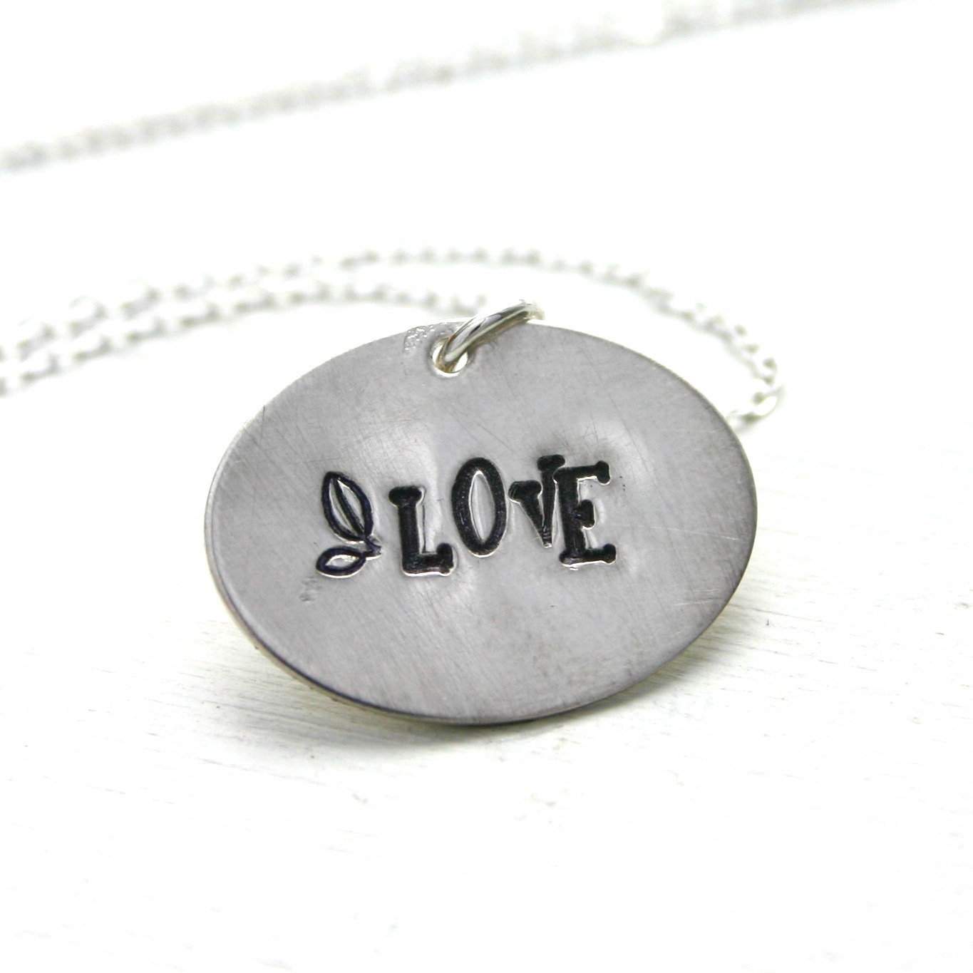 Hand stamped LOVE necklace on oval sterling silver charm