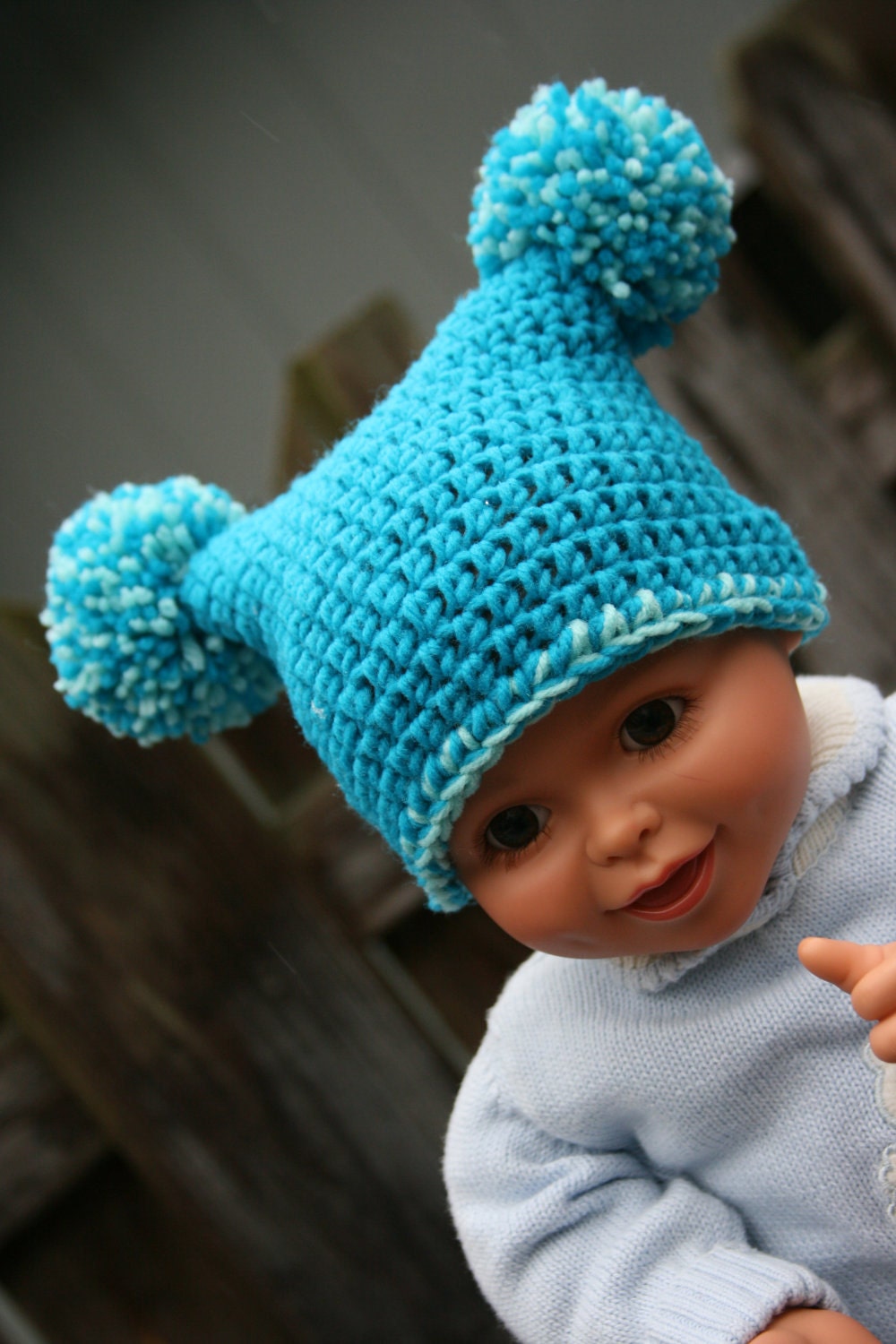 Baby boy or girl hat jester pom crocheted in teal and aqua blue with two color pom poms. Gender neutral newborn to 3 months