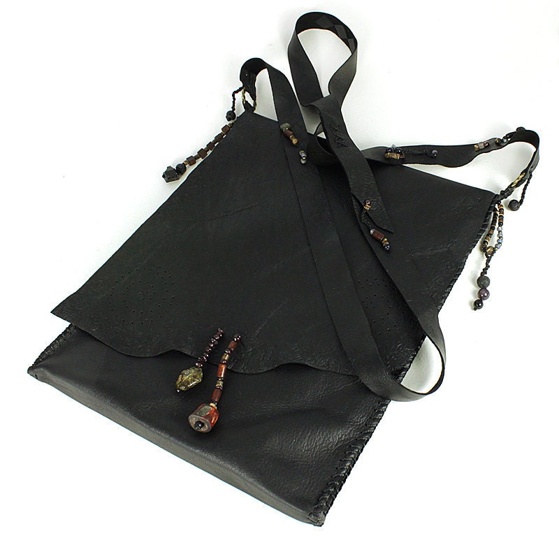 iPad sleeve in black leather with shoulder strap, leather wrapper bag in style of talismanic medicine pouch