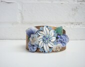 Vintage brass cuff bracelet with beautiful periwinkle and white vintage piece at the center,  , flowers, crystals, rhinestones and leaves