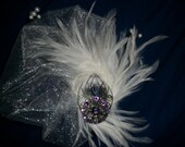 Beautiful White feather fascinator with Amethyst jewel accent