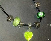 24" handmade  necklace with silver spacers and a green heart pendant