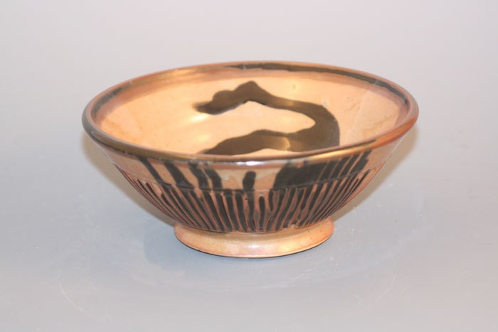 A small individual bowl that goes with the larger serving bowl.