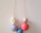 Beautiful glossy hand painted large wooden bead necklace on thin cream cord
