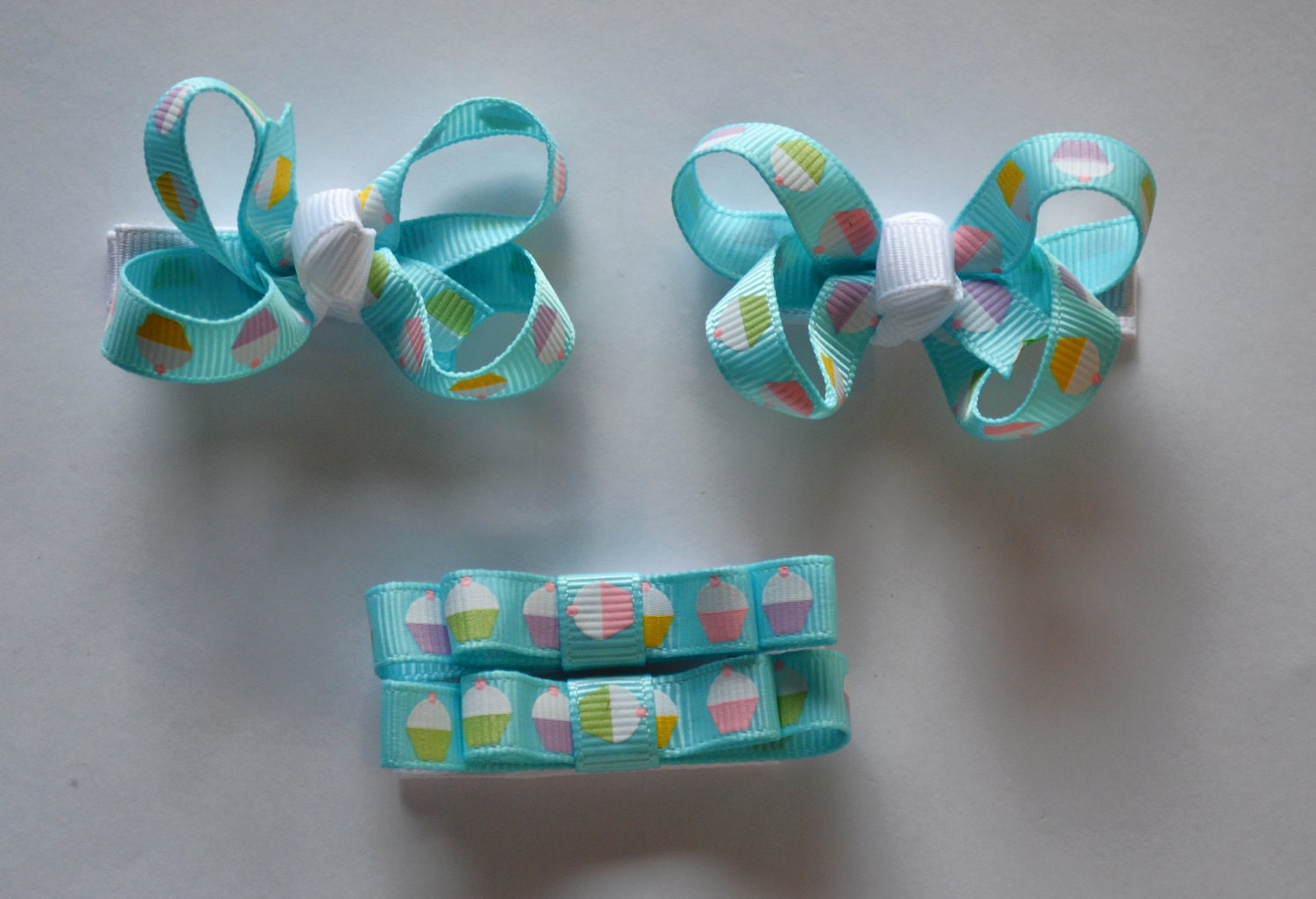 Itty bitty bow clip set. Blue cupcake print