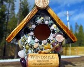 Mosaic birdhouse with natural earth elements such as rocks, wine corks, and Colorful agates