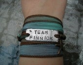 The Hunger Games Bracelet Wrap - TEAM FINNICK Hand Stamped  with Sea Foam Green/ Blue Silk Ribbon Wrap