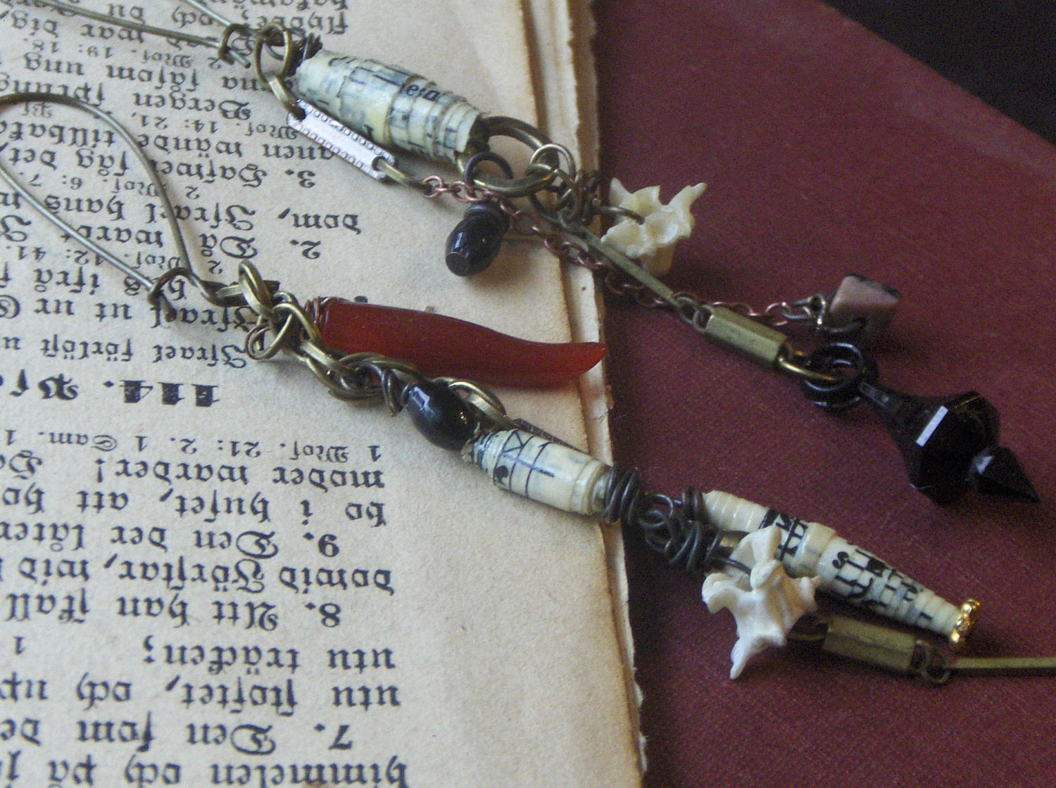 Deliver Us From Evil. Talismans. Snake Vertebra, Rolled Hymnal paper beads, dagger, talon rosary and gemstone Rustic asymmetrical earrings