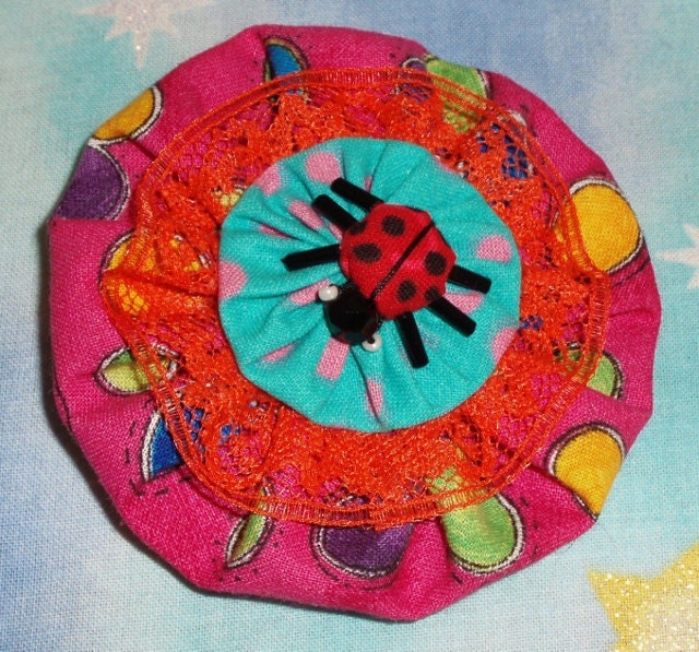 Pink, orange, aqua, ladybug yo yo flower brooch for spring, summer
