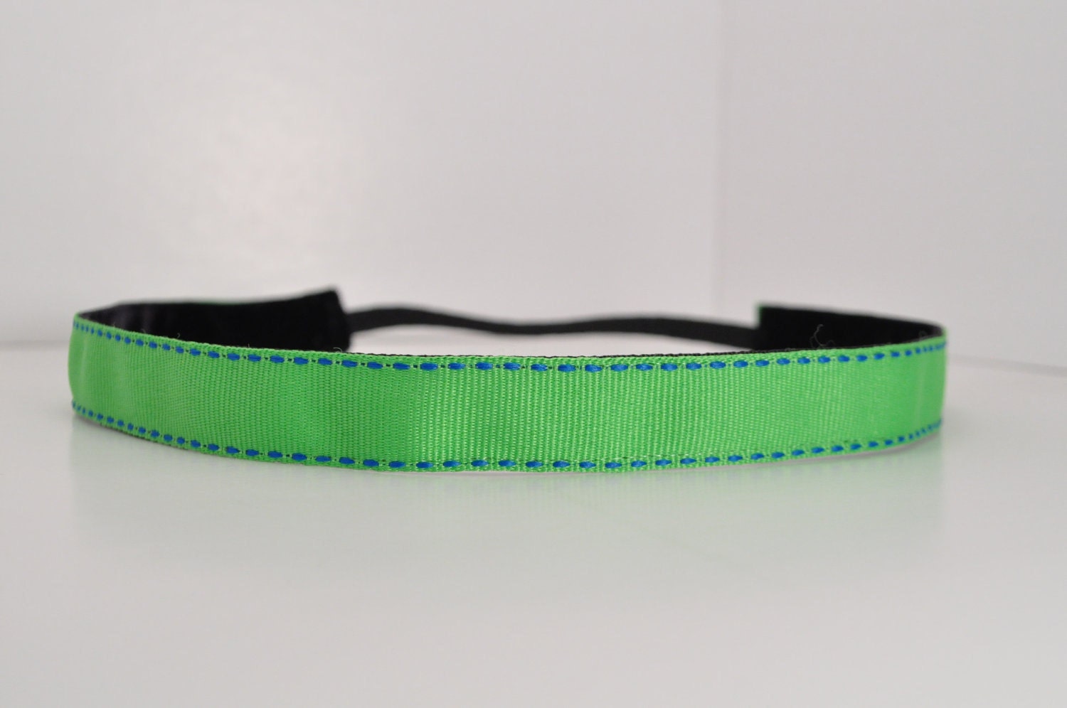 Band-It Headband.... Solid Bright Green with a Blue Stitch - Skinny.  Will stay put and not slip.