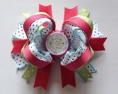 Adorable princess bottle cap hair bow. Pink, white, blue.