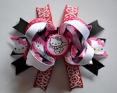 Adorable Hello Kitty bottlecap hair bow. Pink, black, white