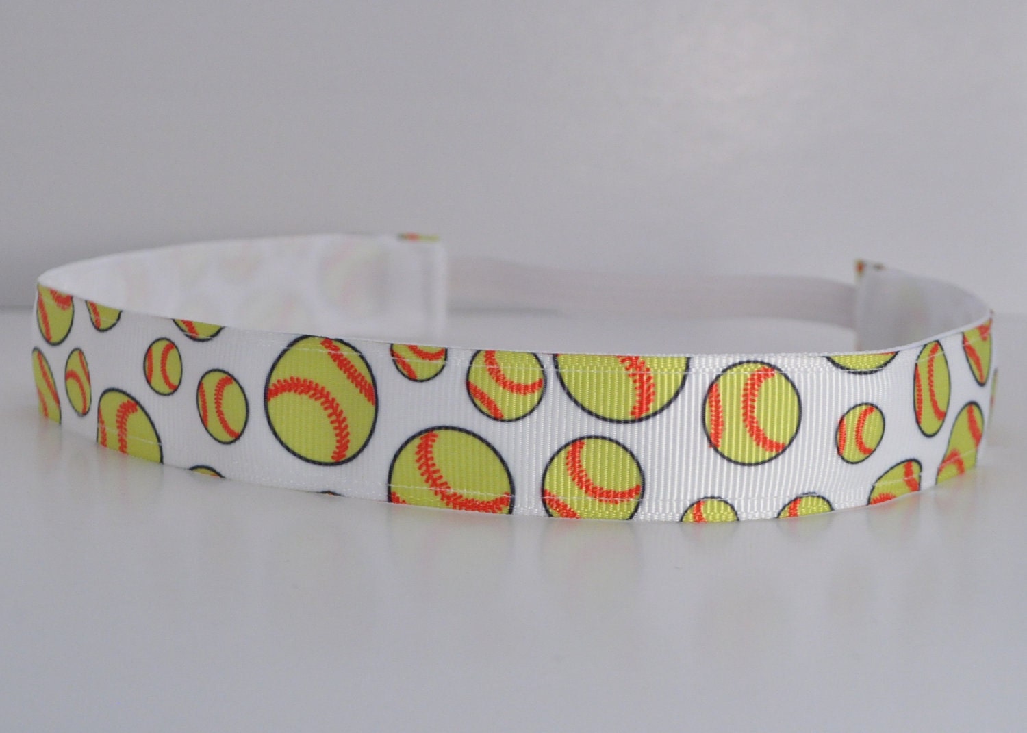Band-It Headband .... Softball.  Will stay put and not slip.