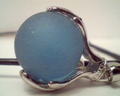 Genuine rare baby blue beach sea glass marble held by hands pendant handmade necklace