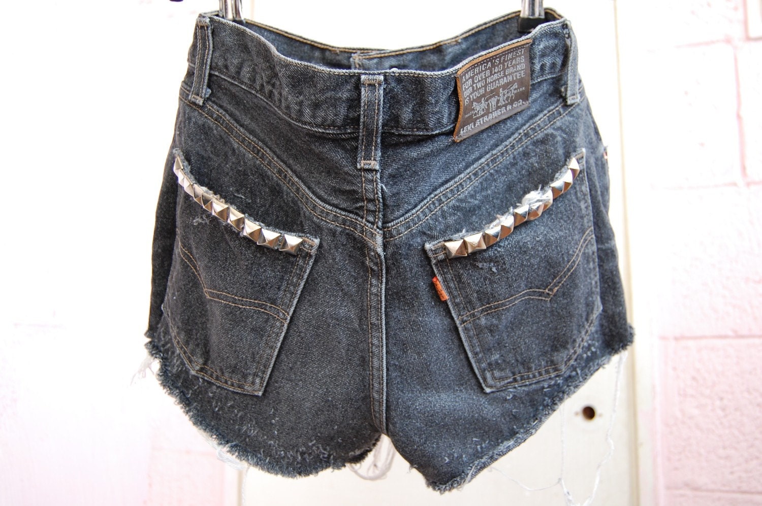 used studded black levis cut offs