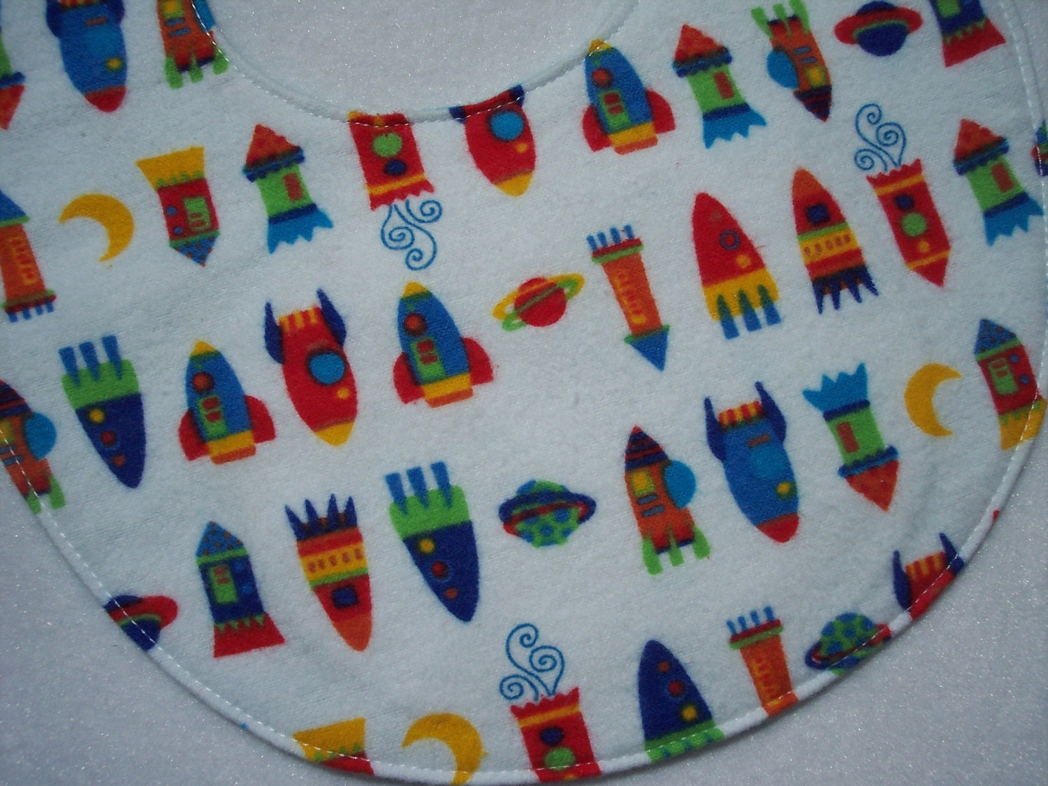 Baby bib, four soft layers, reversible, white with colorful space ships
