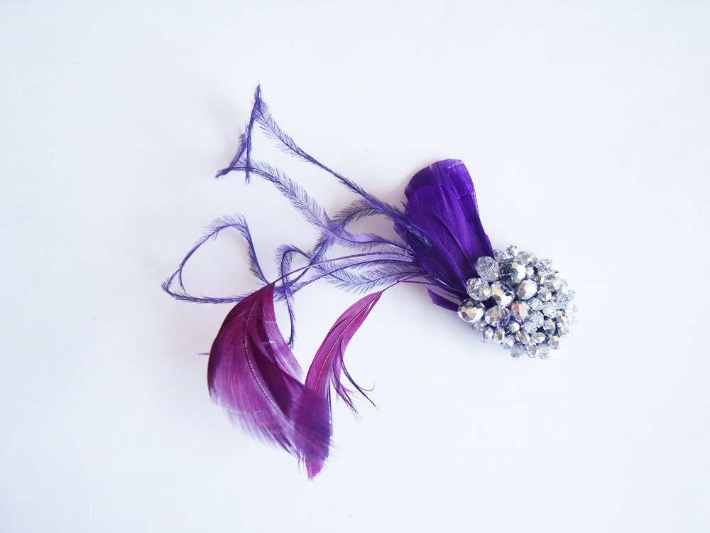 An elegant and small feather alligator clip featuring dark purple goose 