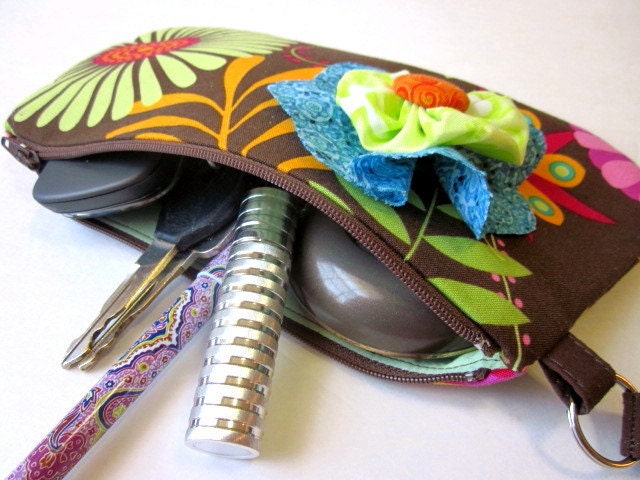 Wristlet  with paisley design and floral brooch