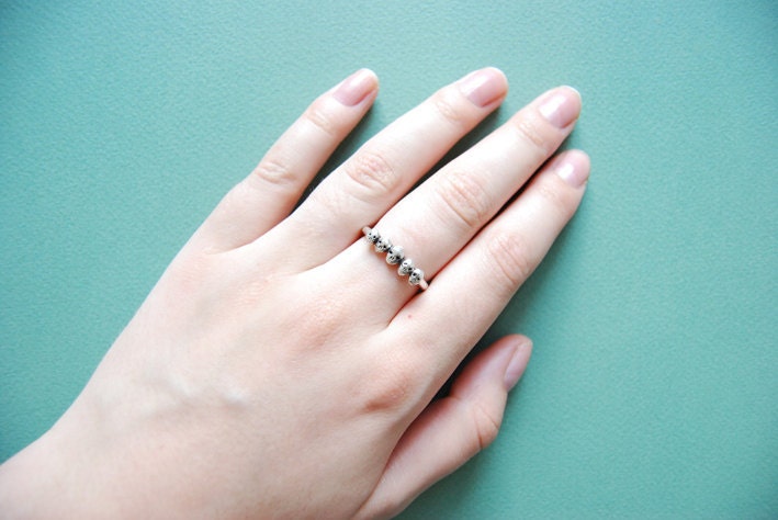 Row of tiny skulls sterling silver ring