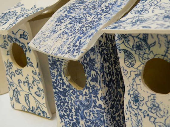 Bird house with blue floral decoration
