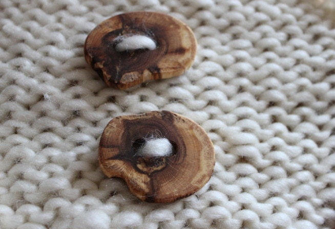 A pair of hancrafted wooden buttons