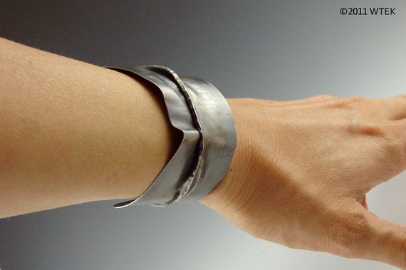 Angled silver cuff worn