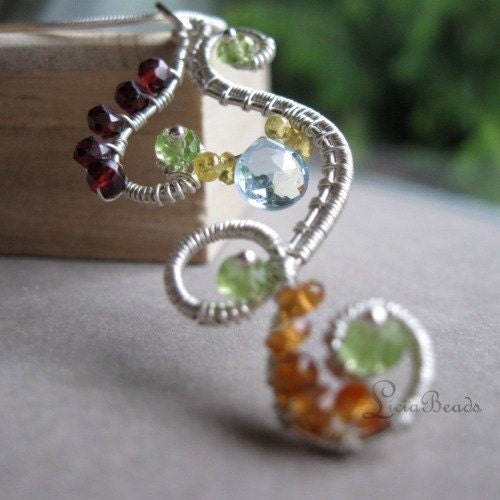 Intricate sterling silver wire wrapped pendant necklace with garnet, peridot, sapphire, and blue topaz