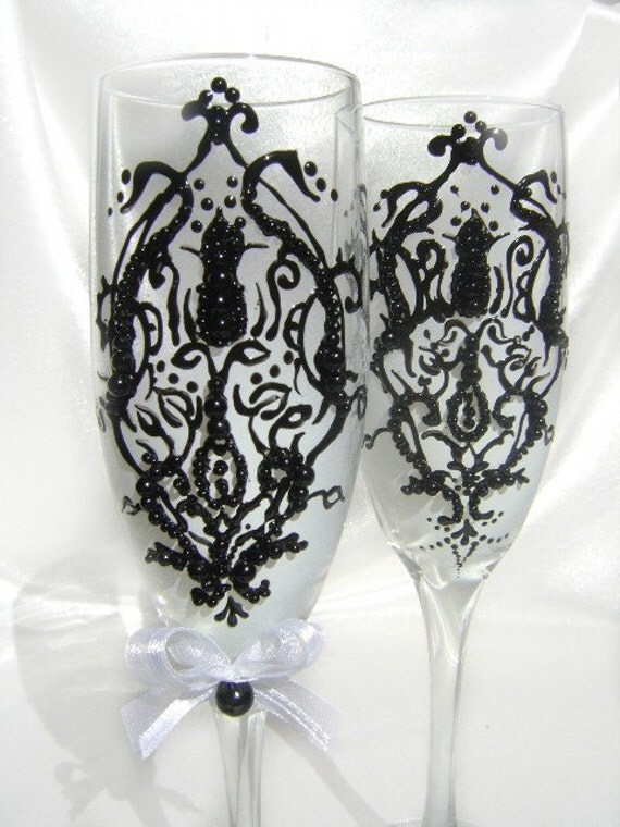 Wedding champagne glasses hand decorated with a black damask on a white 