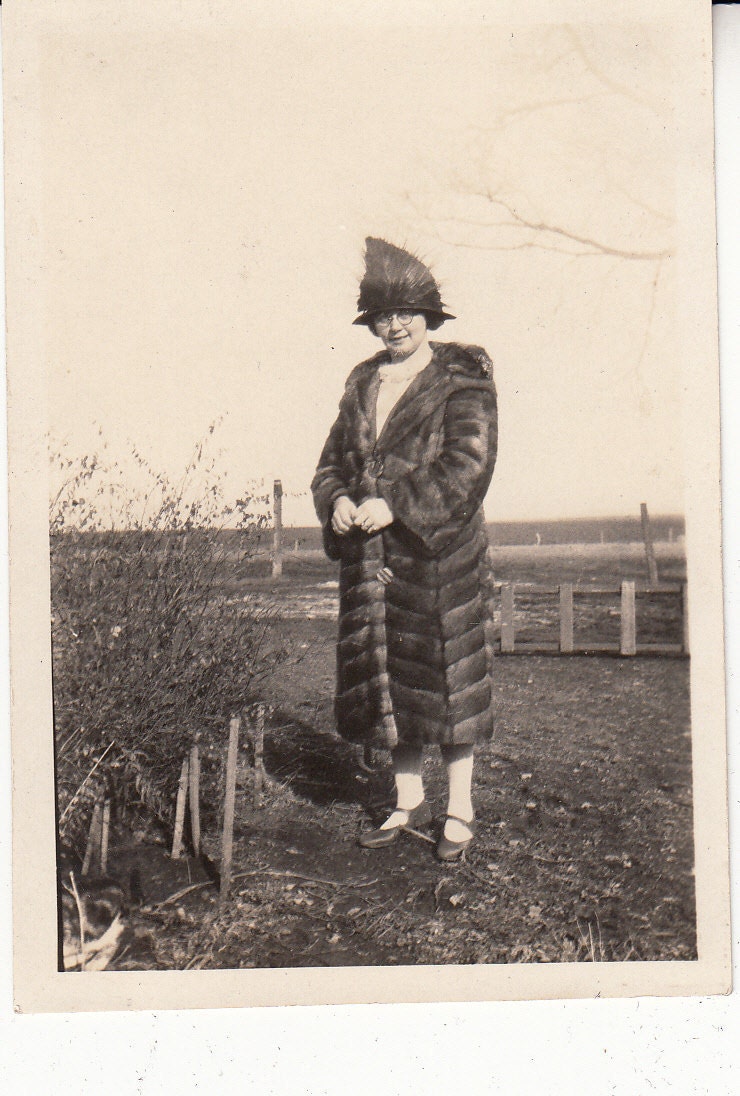 Vintage/Antique photo of a woman in a fur coat and interesting hat