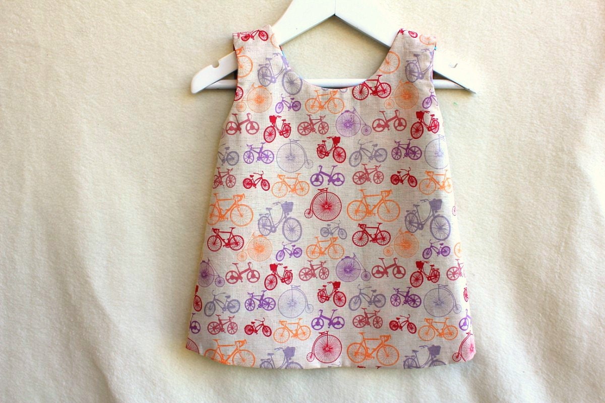 Girl's Reversible Pinafore. Made to Order, Size NB - 5/6. Funky Flowers and Bikes. Designer Print.