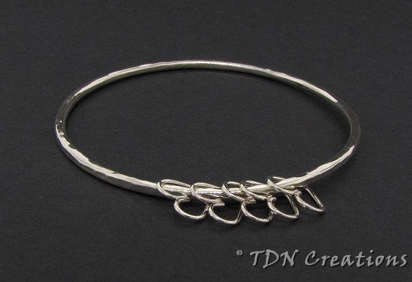 Bangle with dangling hearts in sterling silver