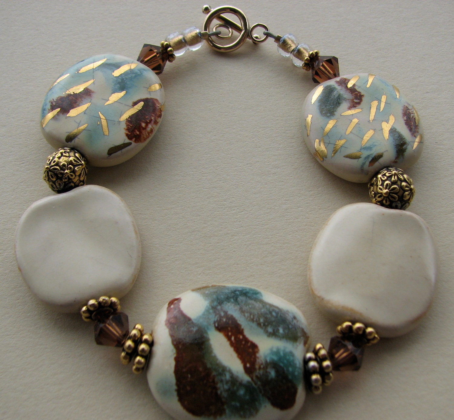 Cream, Gold, and Bronze Kazuri and Swarovksi Beaded Bracelet