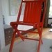 Red-painted folding wooden chair