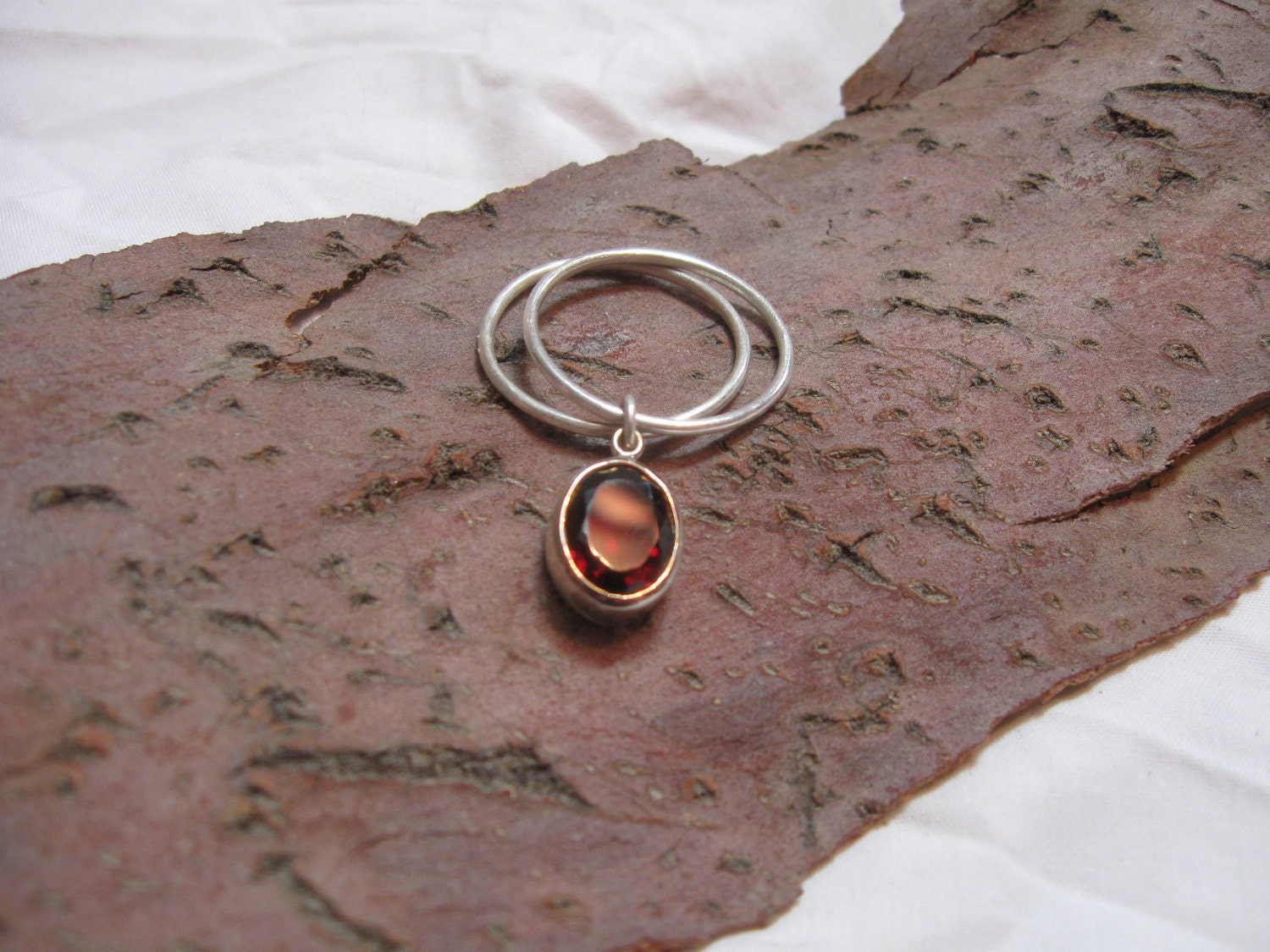 Sterling silver charm rings with bezel set with faceted oval garnet