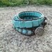 Turquoise dyed magnesite and brown leather triple wrap bracelet with Celtic knot button closure
