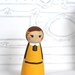 Jane the wood doll is yellow and chocolate