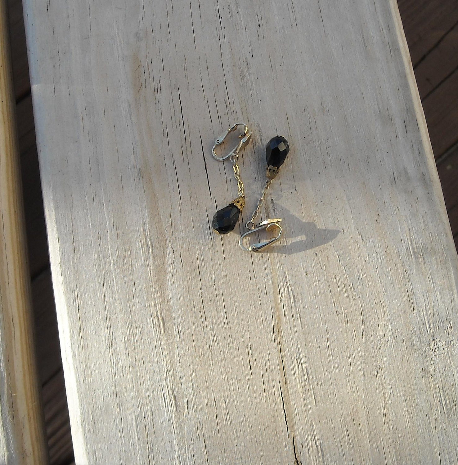 Black teardrop goldtone clip-on earrings