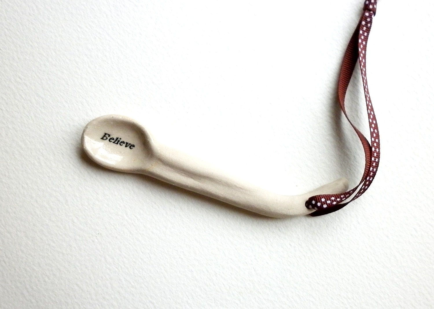 A handmade ceramic Believe Design Spoon